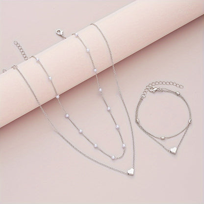 SET DI GIOIELLI CON CUORE STRATIFICATO E PERLE