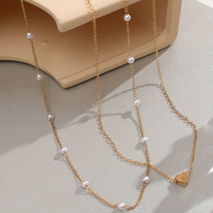SET DI GIOIELLI CON CUORE STRATIFICATO E PERLE